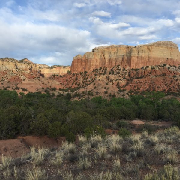 View of Kitchen Mesa from the casitas. Here you can see the brittle Chinle formation at the very bottom overlain by the Morrison cliff-forming formation and capped with the grey, rounded Todilto formation